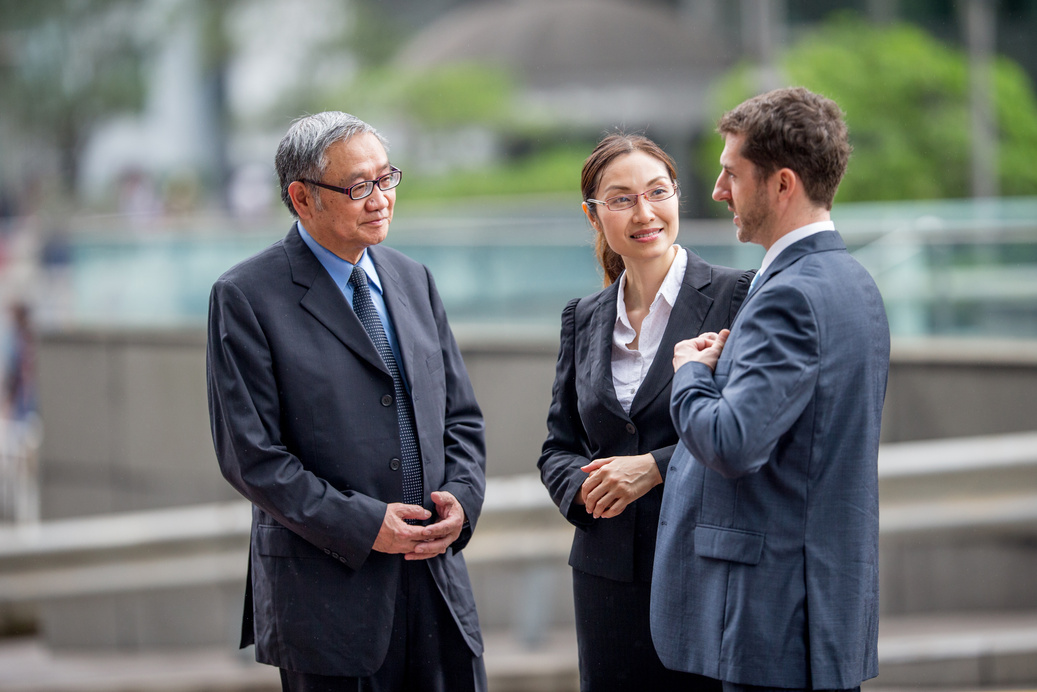 Multiethnic Businessmen Conversing with a Translator